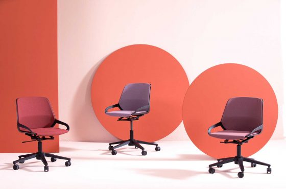 Drei aeris Numo Task Schreibtischstühle in rötlichen Farbtönen.